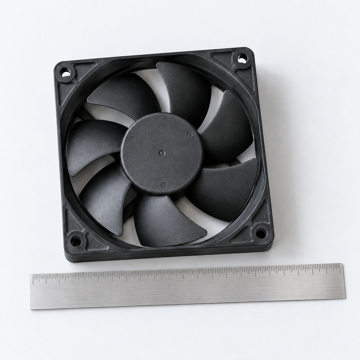Photo-style illustration of a cooling fan beside a metal ruler; example of the frame dimensions to photograph.