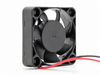 Compact square axial fan with two leads — retouched existing listing photograph, angled blade-side view; model unconfirmed