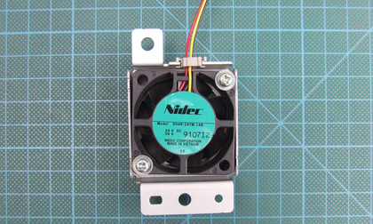 Different-unit Nidec D04R-24TM 14B, 24V DC 0.06A, with extra external metal bracket and screws absent from historical bare-fan view; hardware inclusion, assembly fit and supplied condition unverified. Source 9107I2 versus historical 9409K1.
